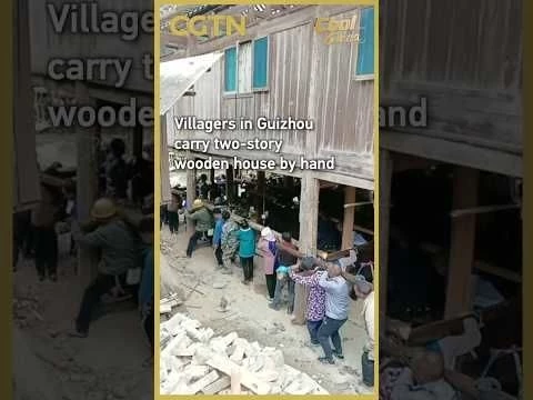 Villagers in Guizhou carry two-story wooden house by hand